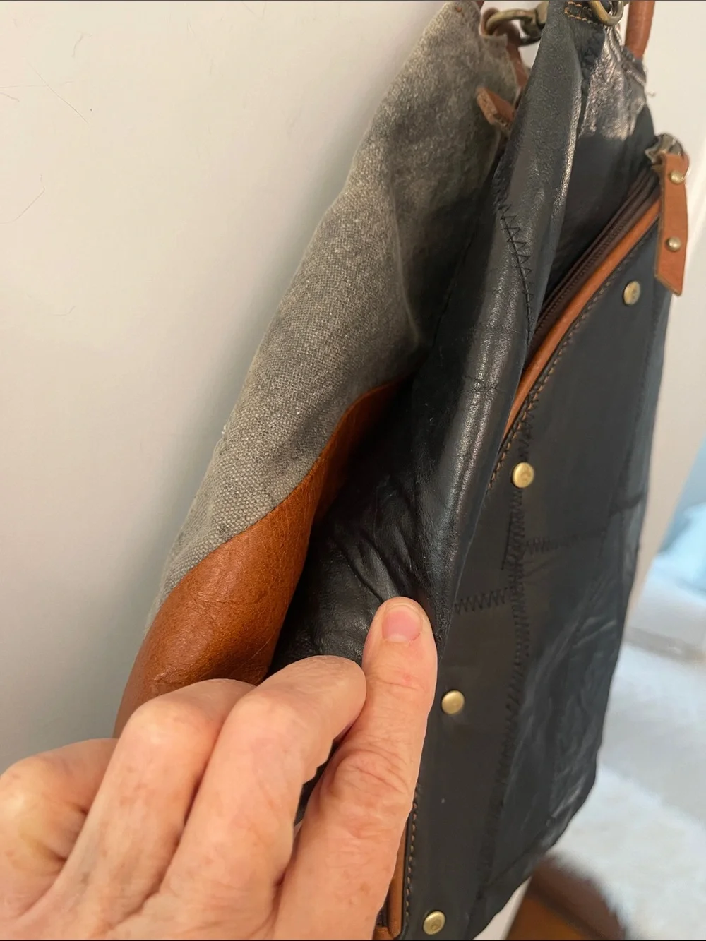 Black Leather Backpack with Brown Trim and Brass Accents